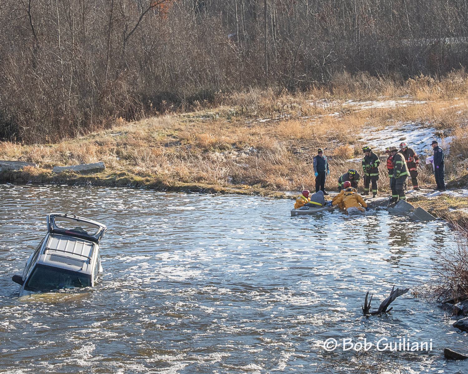 Clare Fire Department personnel rescue a Farwell woman from her sinking car Sunday